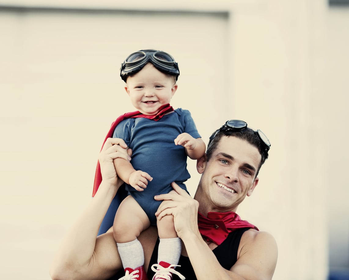 Dad and son wearing hero capes