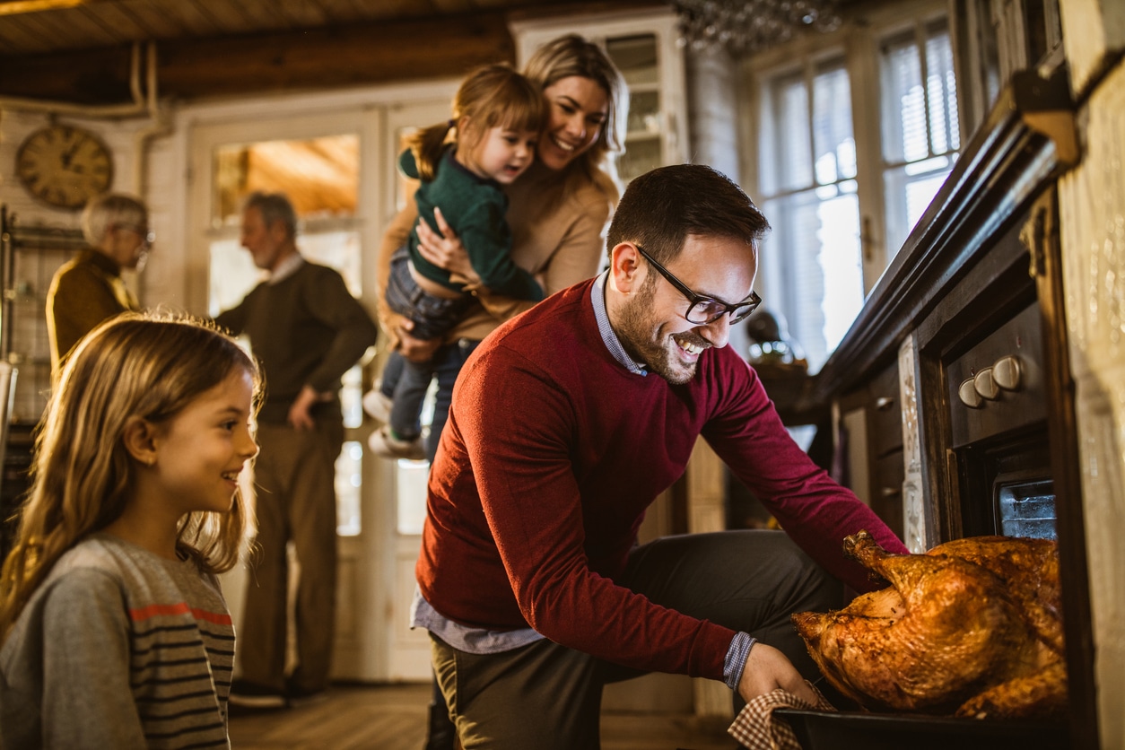 family celebrating the holidays together with turkey